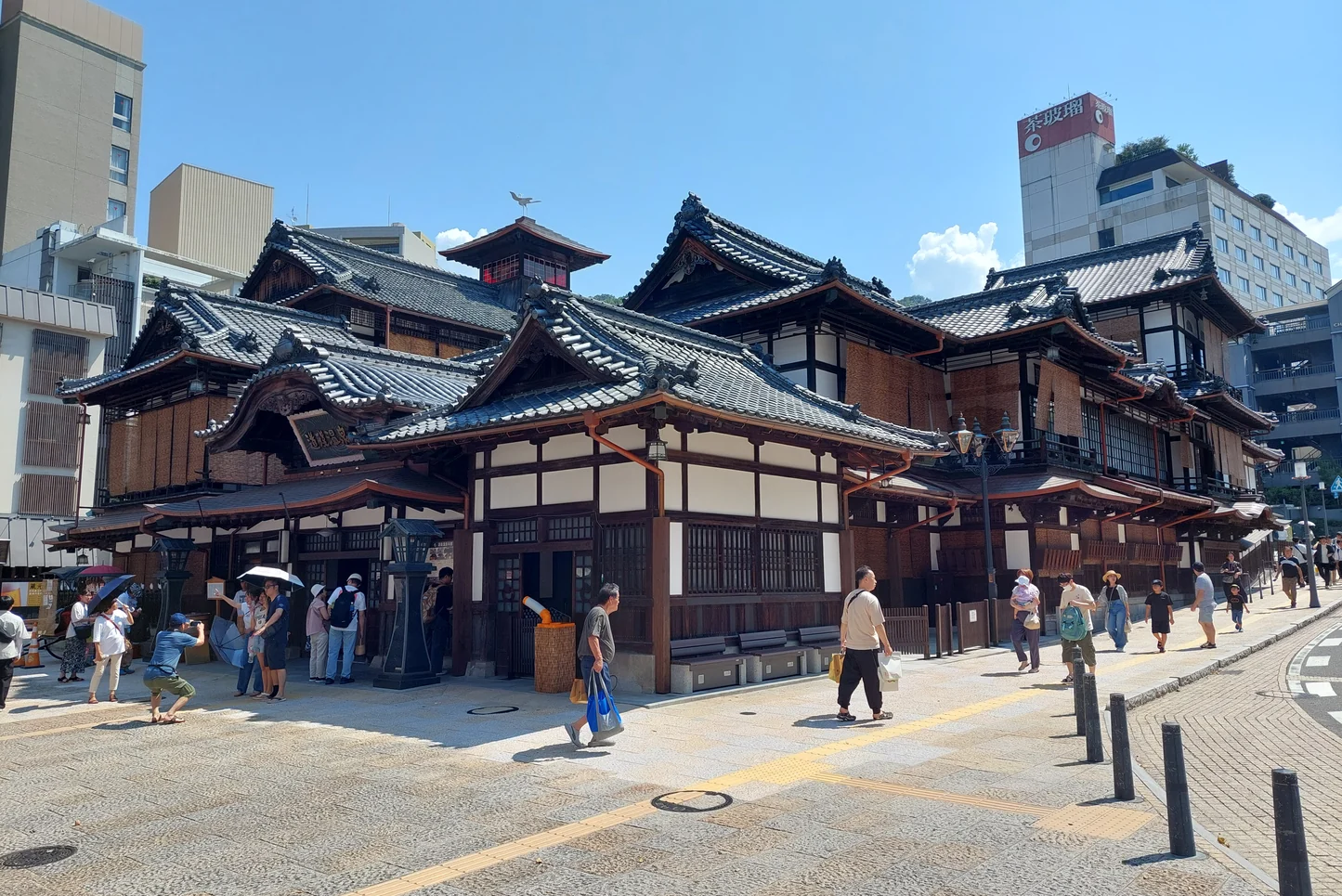 Dogo Onsen Honkan’s tiled-roof exterior and street, photographed in August 2024