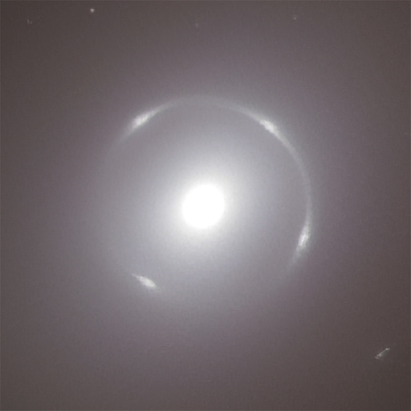 Euclid observation of NGC 6505: a thin ring, with four brighter patches, surrounds the bright central region of a galaxy.